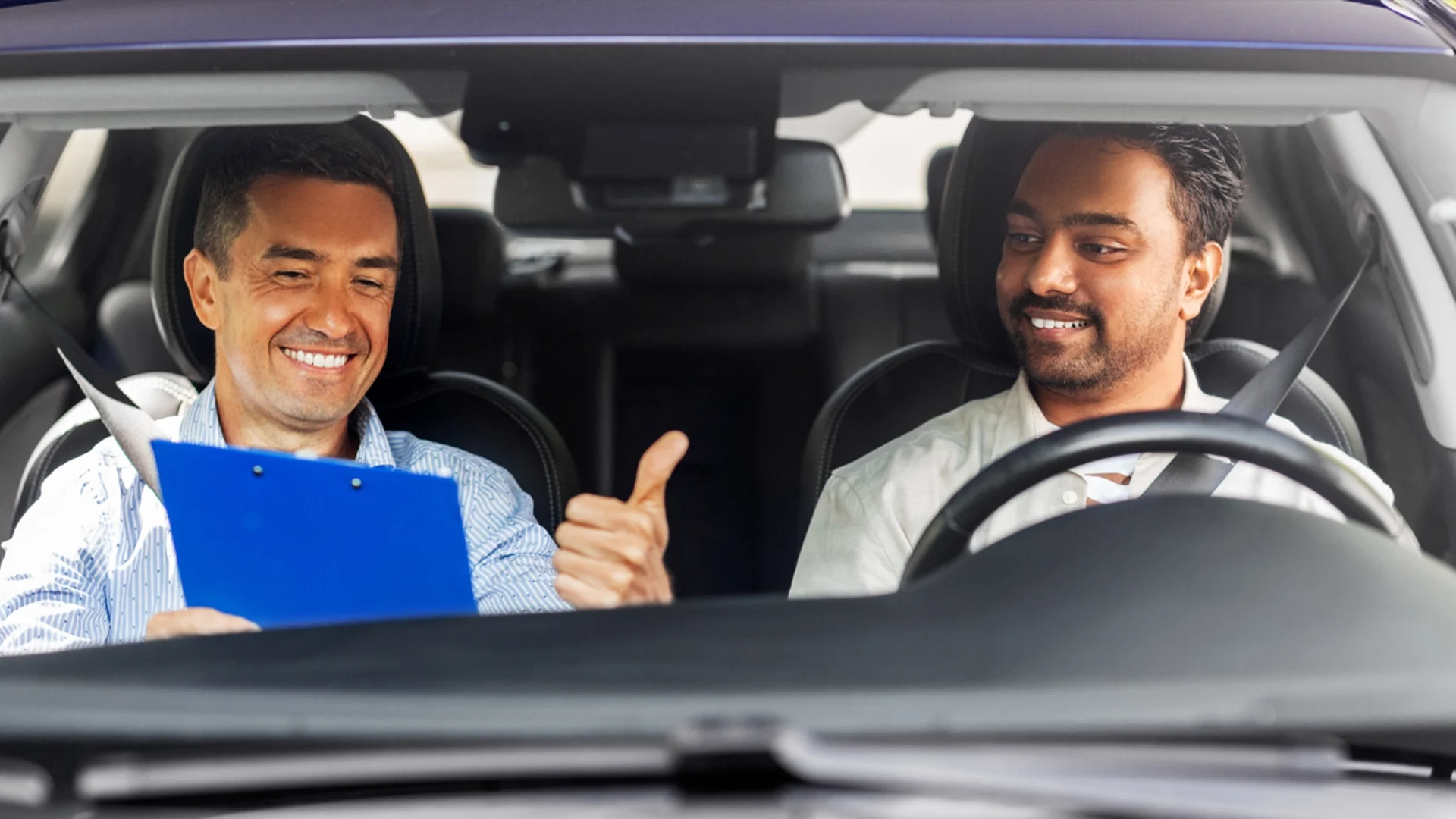 Student and road test examiner in car